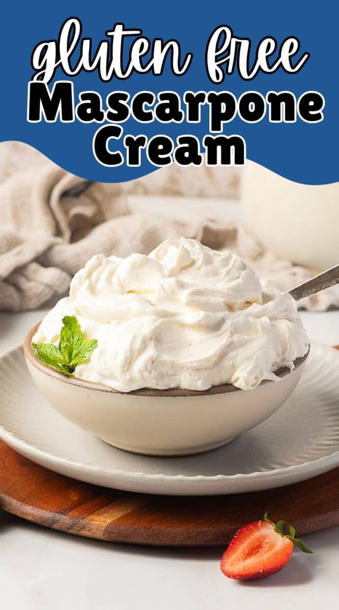 A bowl of mascarpone whipped cream topped with a mint leaf, with a spoon inside, sits on a wooden board beside a halved strawberry. Text above reads "gluten free Mascarpone Cream.