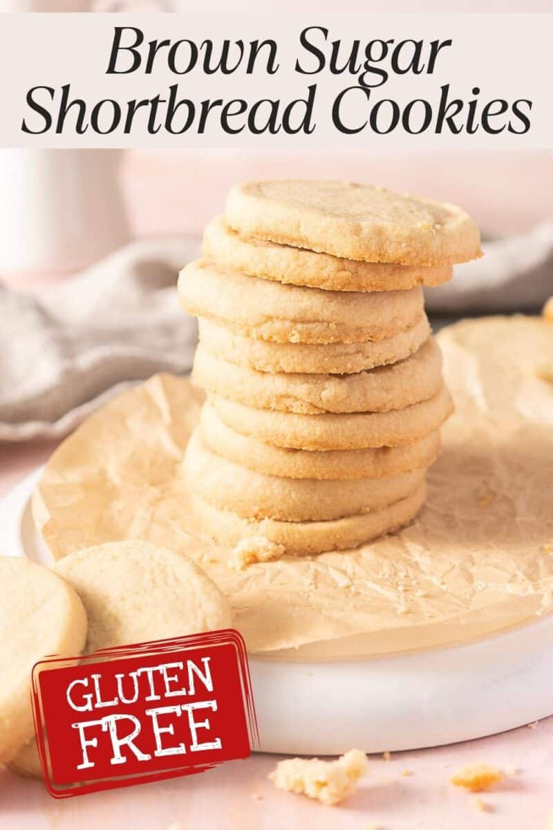 A stack of round gluten free shortbread cookies rests on parchment paper, each golden treat labeled for its deliciously sweet, worry-free enjoyment.