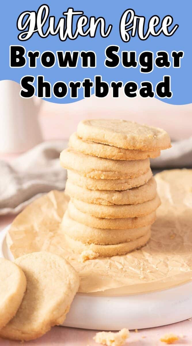 A stack of gluten free shortbread cookies made with brown sugar sits on parchment paper, with a few cookies laid flat nearby.