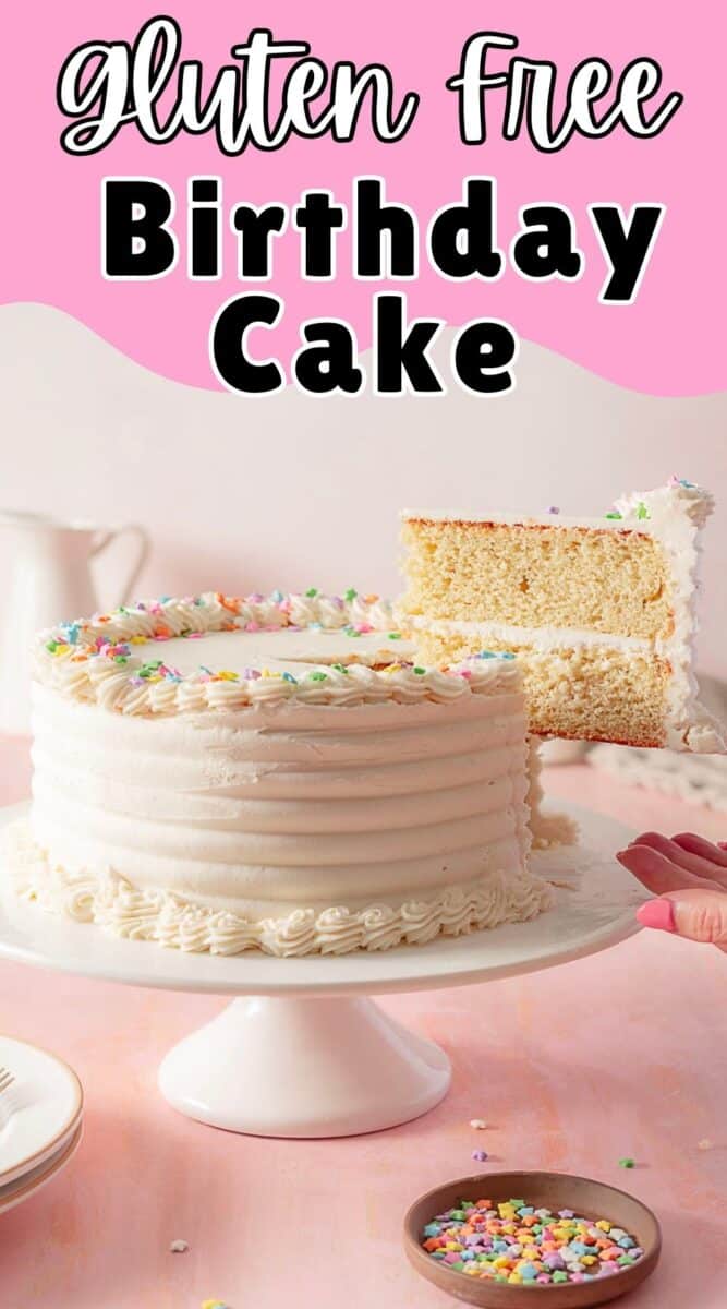 A gluten free vanilla cake with white frosting and colorful sprinkles is displayed on a cake stand, with one slice being served.