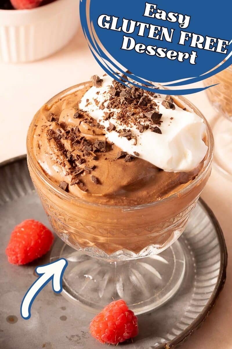 A glass dish of dairy free chocolate mousse topped with whipped cream and chocolate shavings, on a plate with two raspberries; text reads "Easy GLUTEN FREE Dessert.