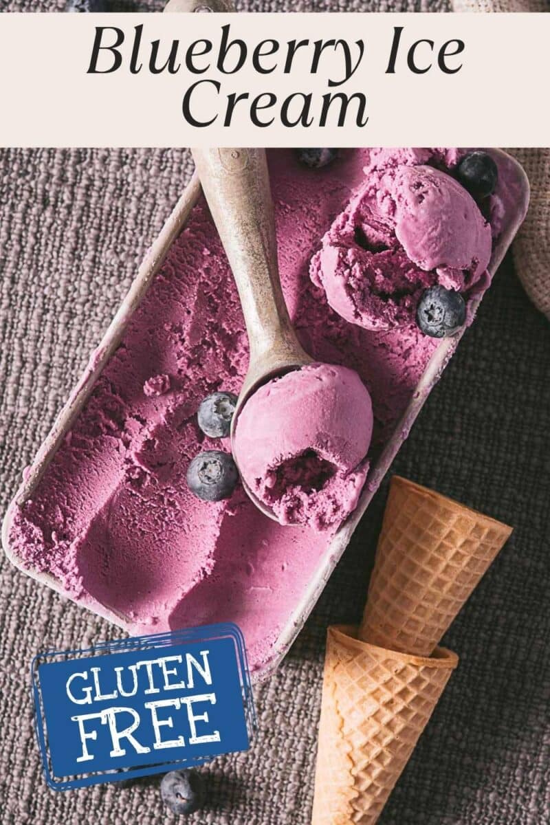 Rectangular container of no eggs blueberry ice cream with a scoop and fresh blueberries, next to two empty waffle cones. Text reads "Blueberry Ice Cream" and "Gluten Free.