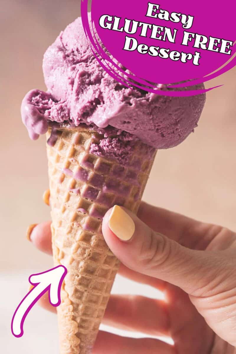 A hand holding a waffle cone with a scoop of purple no eggs blueberry ice cream; text at the top reads "Easy Gluten Free Dessert.