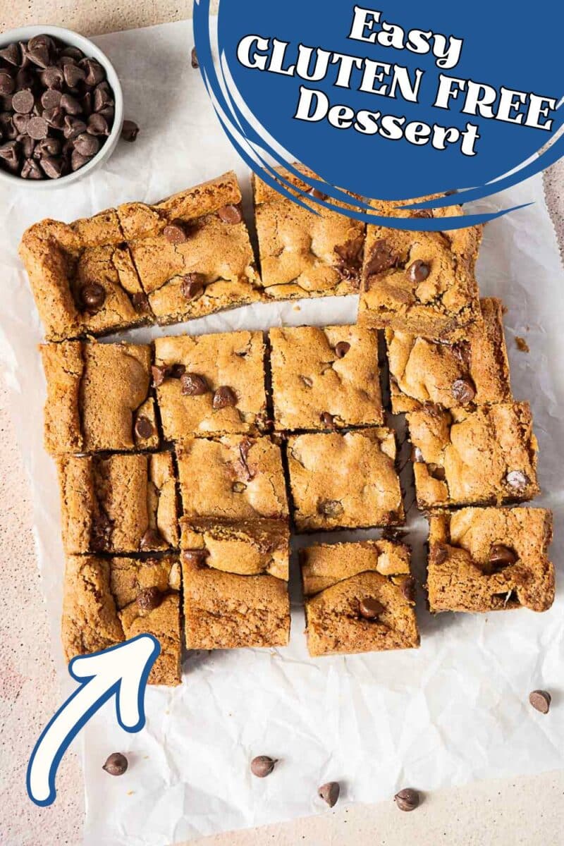Sliced gluten free chocolate cookie bars with chocolate chips on parchment paper, a bowl of chocolate chips nearby, and text overlay reading "Easy Gluten Free Dessert.