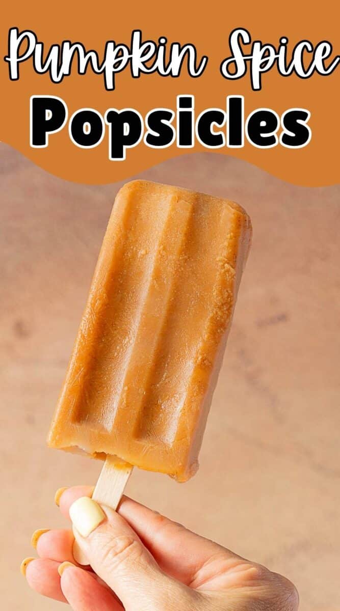 A hand holds a pumpkin popsicle against a neutral background with the text "Pumpkin Spice Popsicles" at the top.
