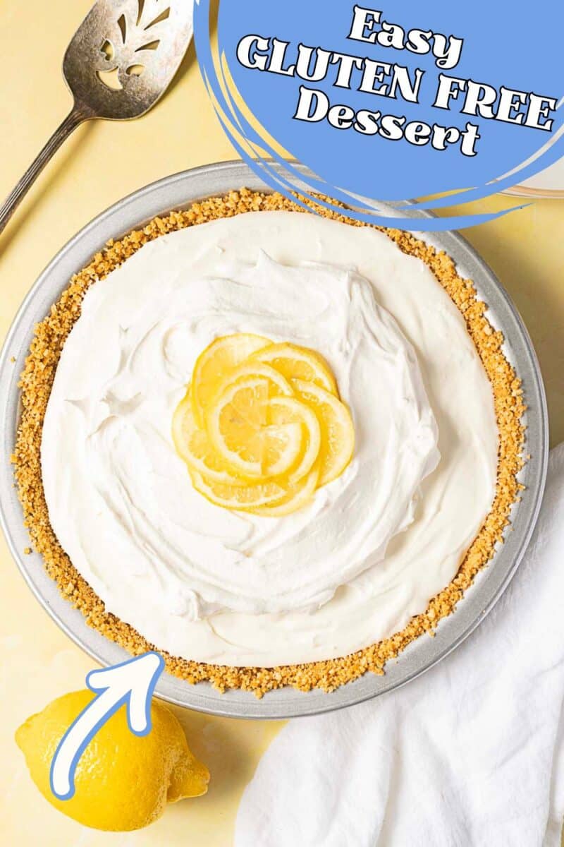 A gluten free lemon pie with a graham cracker crust, topped with whipped cream and lemon slices