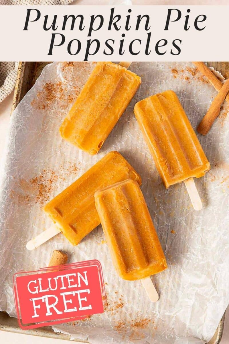 Four creamy pumpkin popsicles on parchment paper, with a "Gluten Free" label in the corner for a delicious seasonal treat.