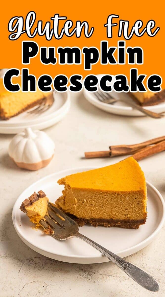 A slice of gluten free pumpkin cheesecake sits on a plate with a fork, while the rest of the creamy dessert and cinnamon sticks add cozy charm in the background.