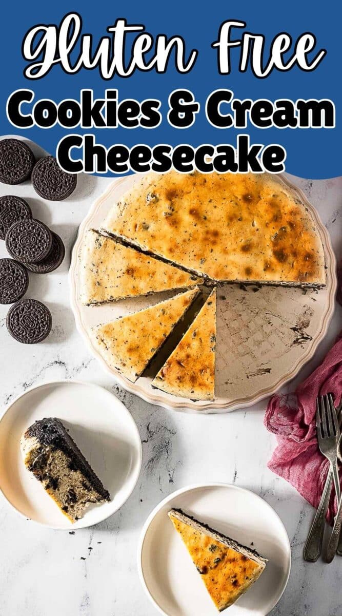 A Gluten Free Oreo Cheesecake sits on a platter with two sliced pieces on plates, surrounded by chocolate sandwich cookies and utensils.