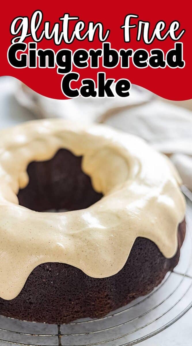 A bundt-shaped gluten free gingerbread cake with light brown icing on top, placed on a cooling rack.