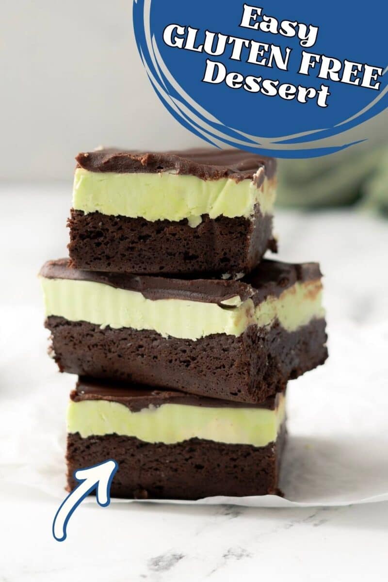 Three stacked gluten free mint chocolate brownies with a green mint layer in the middle and rich chocolate topping.
