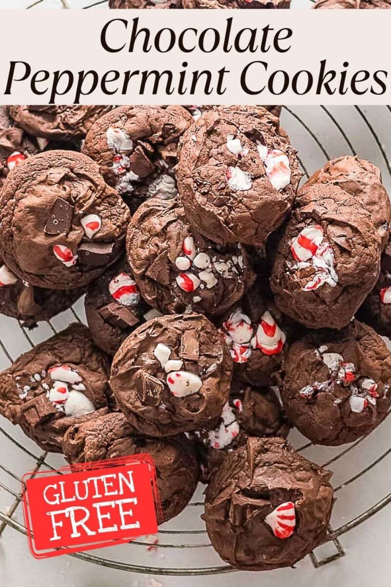 A pile of Gluten Free Chocolate Peppermint Cookies topped with crushed candy canes rests on a cooling rack. A label in the corner reads "Gluten Free.