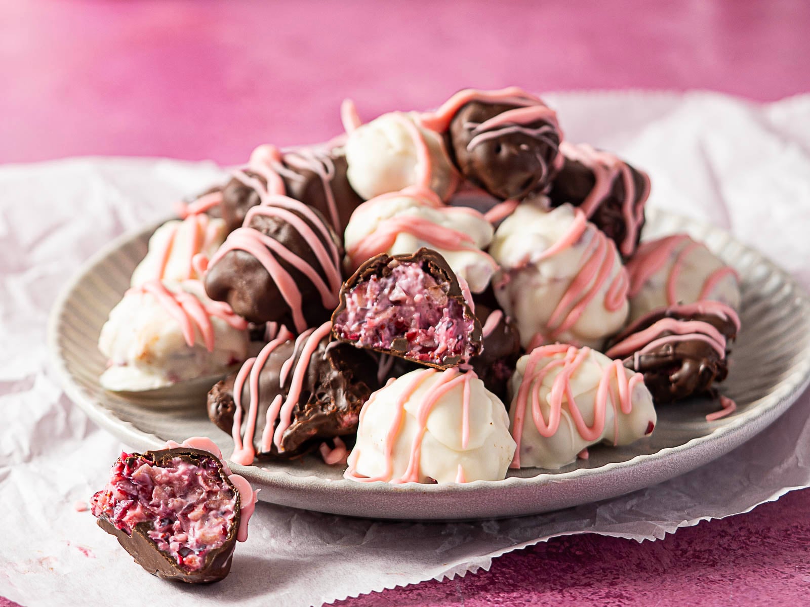 A plate of chocolate covered cranberries.