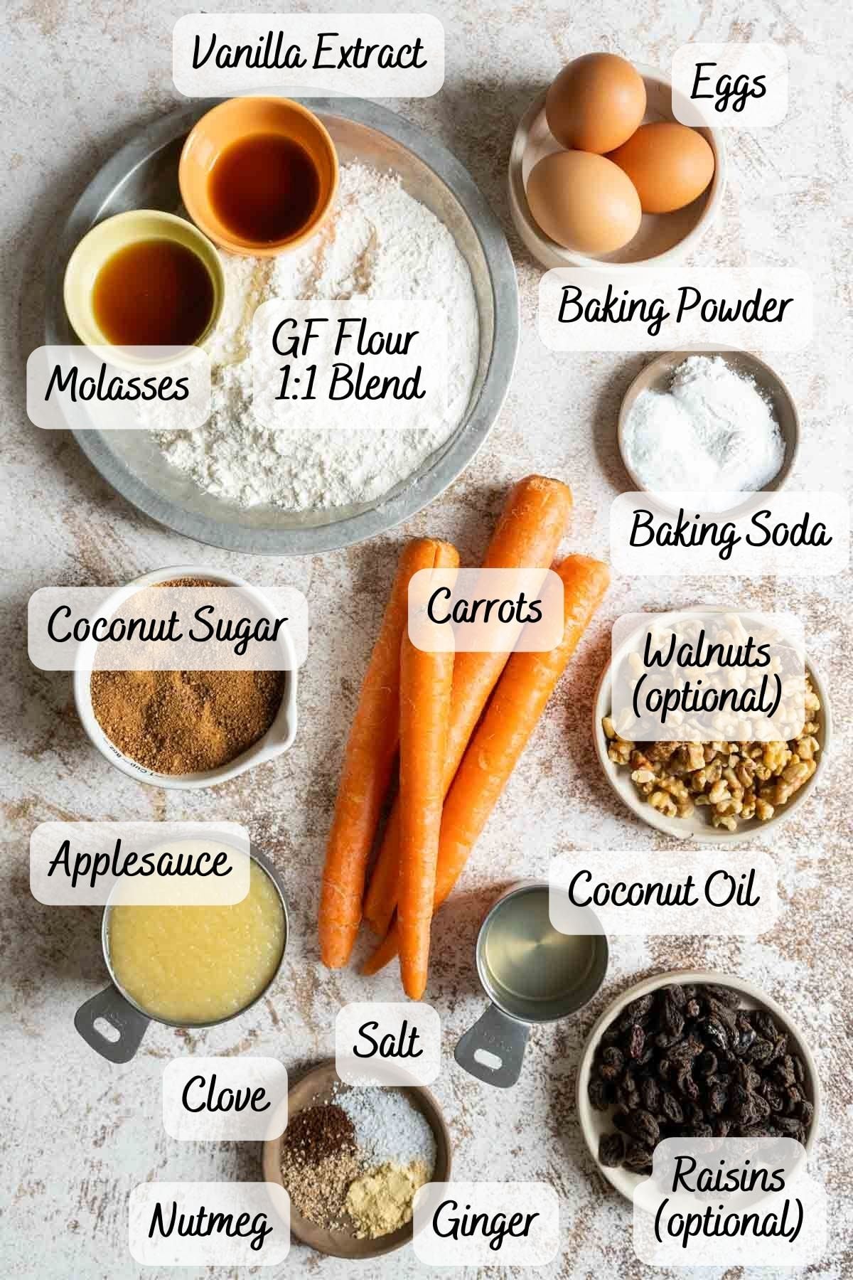 Various carrot cake ingredients, including eggs, gluten-free flour, carrots, applesauce, coconut sugar, walnuts, raisins, spices, baking powder, molasses, coconut oil-and all you need to make a delicious Gluten Free Dairy Free Carrot Cake.