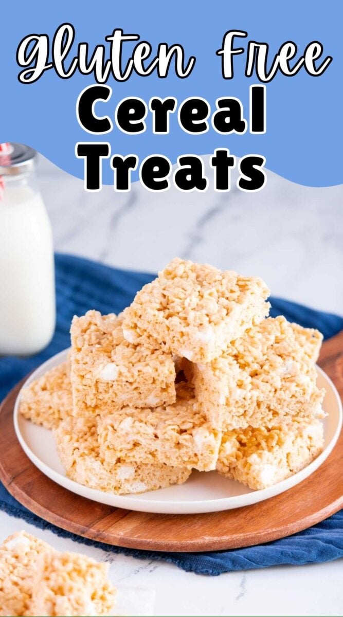 A stack of gluten free rice krispy treats sits on a white plate, with a bottle of milk in the background, ready for a delicious snack.