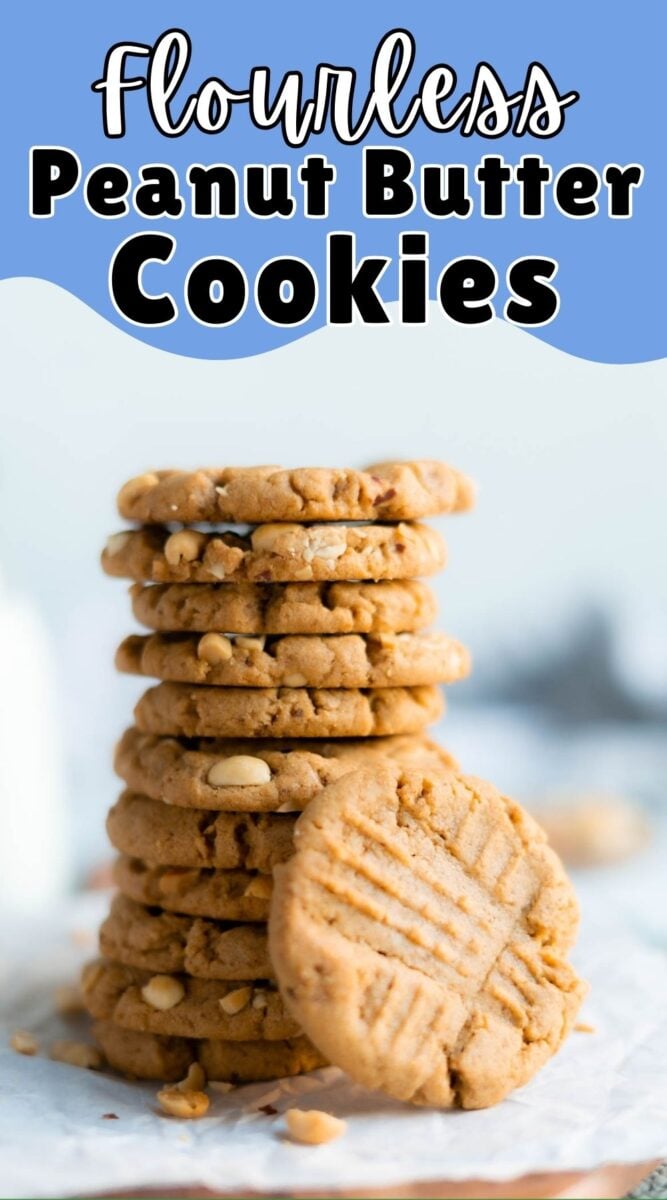 A stack of flourless peanut butter cookies with peanuts is arranged on parchment paper, with one cookie leaning in front and text above reading “Flourless Peanut Butter Cookies.”.