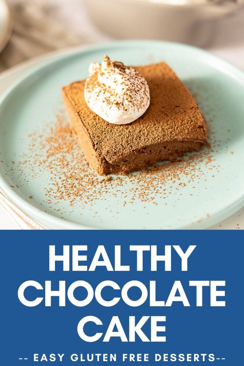 A slice of no bake chocolate cake topped with whipped cream and cocoa powder on a light blue plate, with text reading "Healthy Chocolate Cake - Easy Gluten Free Desserts.