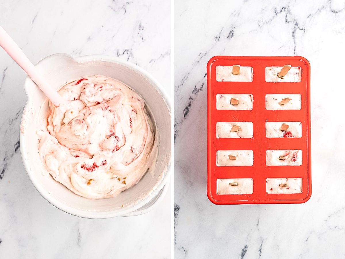 A bowl of creamy mixture with a spatula on the left and a red popsicle mold filled with the mixture and sticks on the right, both on a marble surface.