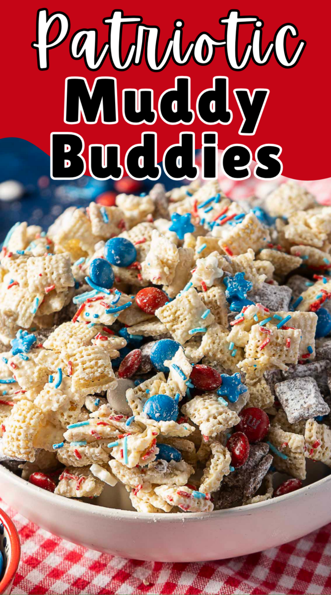 A bowl of patriotic muddy buddies snack mix with Chex cereal, red, white, and blue candies, star-shaped sprinkles, and powdered sugar, on a red and white checkered cloth.