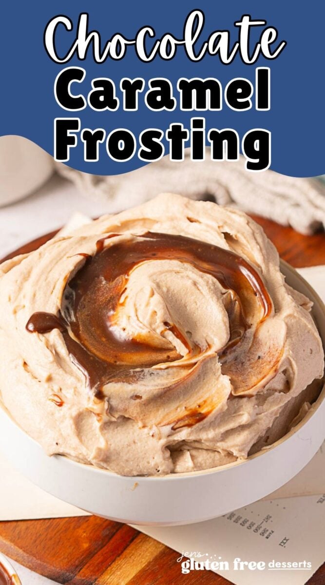 A bowl of rich chocolate caramel frosting with swirls of caramel sauce on top, placed on a wooden surface next to a cloth napkin.