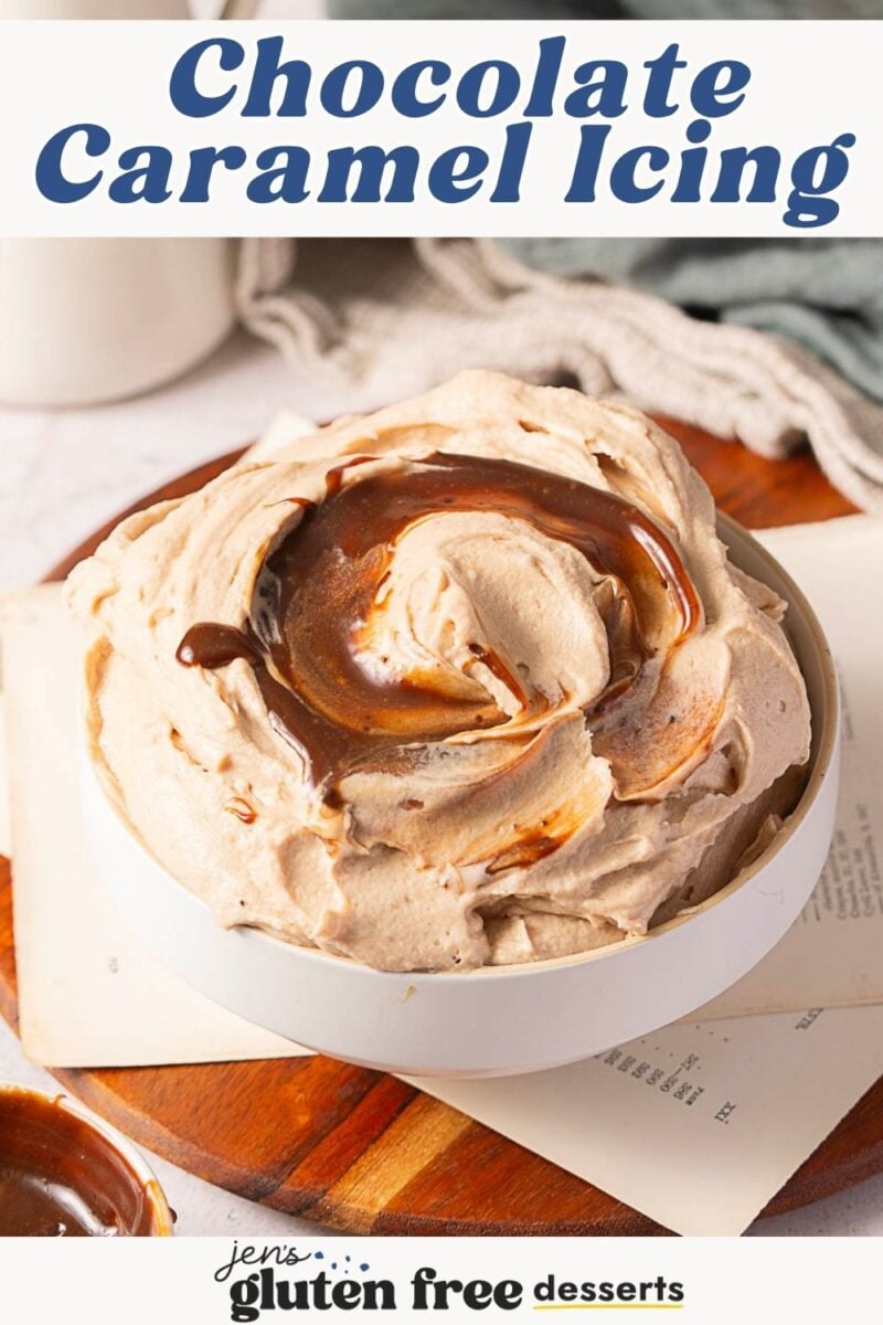 A bowl of thick chocolate caramel frosting with a swirl of caramel sauce on top sits on a wooden board, accompanied by recipe cards.