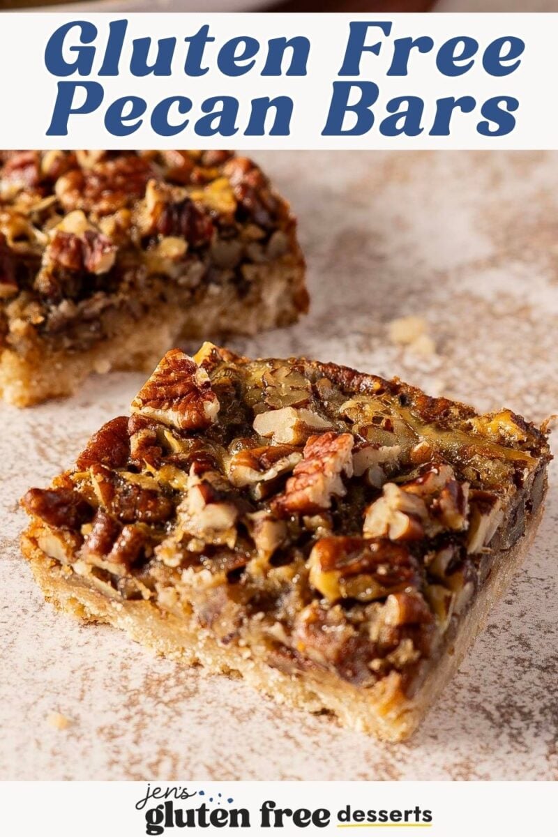 Two gluten-free pecan pie bars on a surface, with the text “Gluten Free Pecan Bars” at the top and the “Jen’s Gluten Free Desserts” logo at the bottom.
