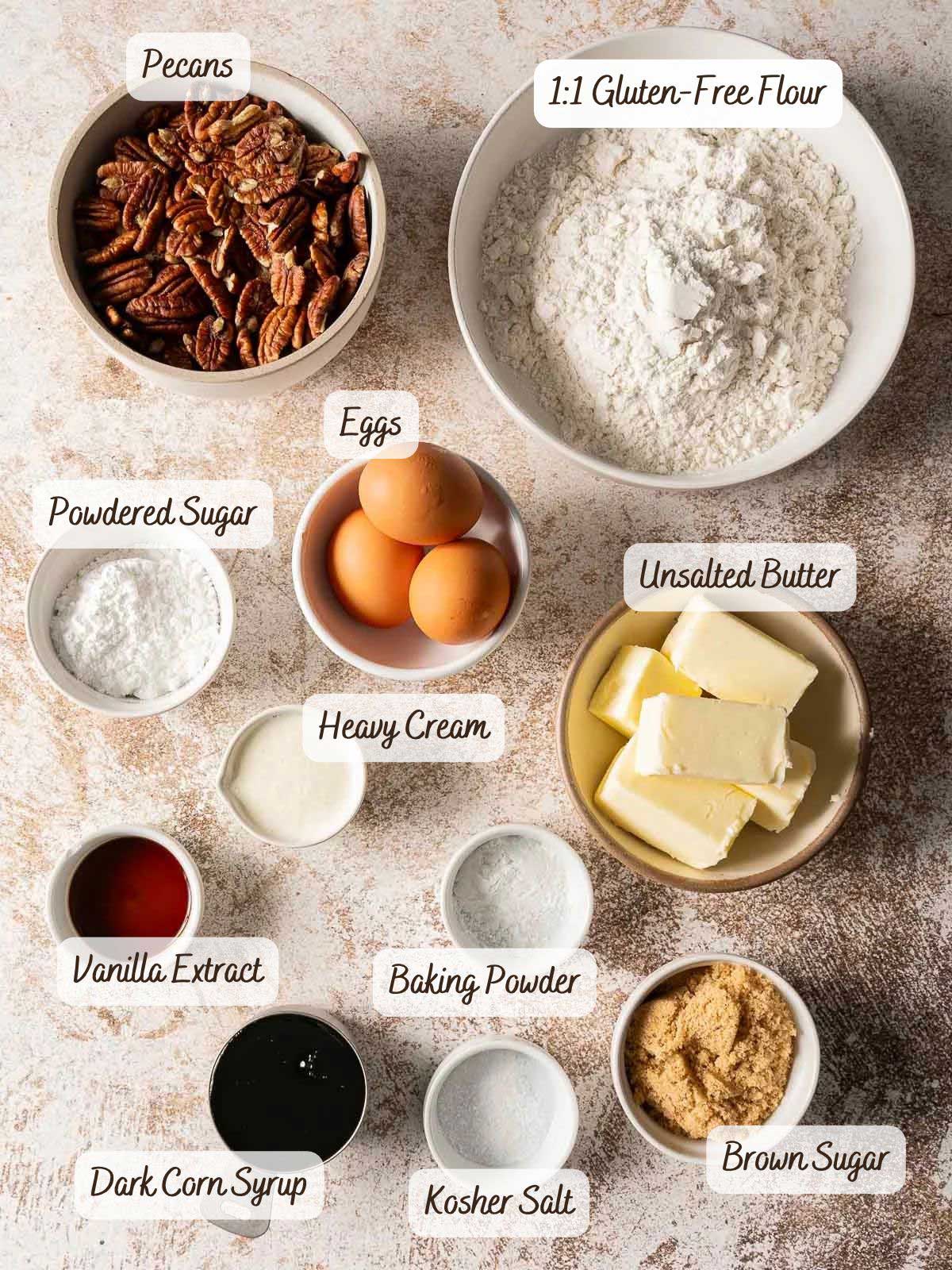 Bowls containing ingredients for gluten-free pecan pie bars: pecans, flour, eggs, powdered sugar, butter, heavy cream, vanilla, baking powder, dark corn syrup, salt, and brown sugar.